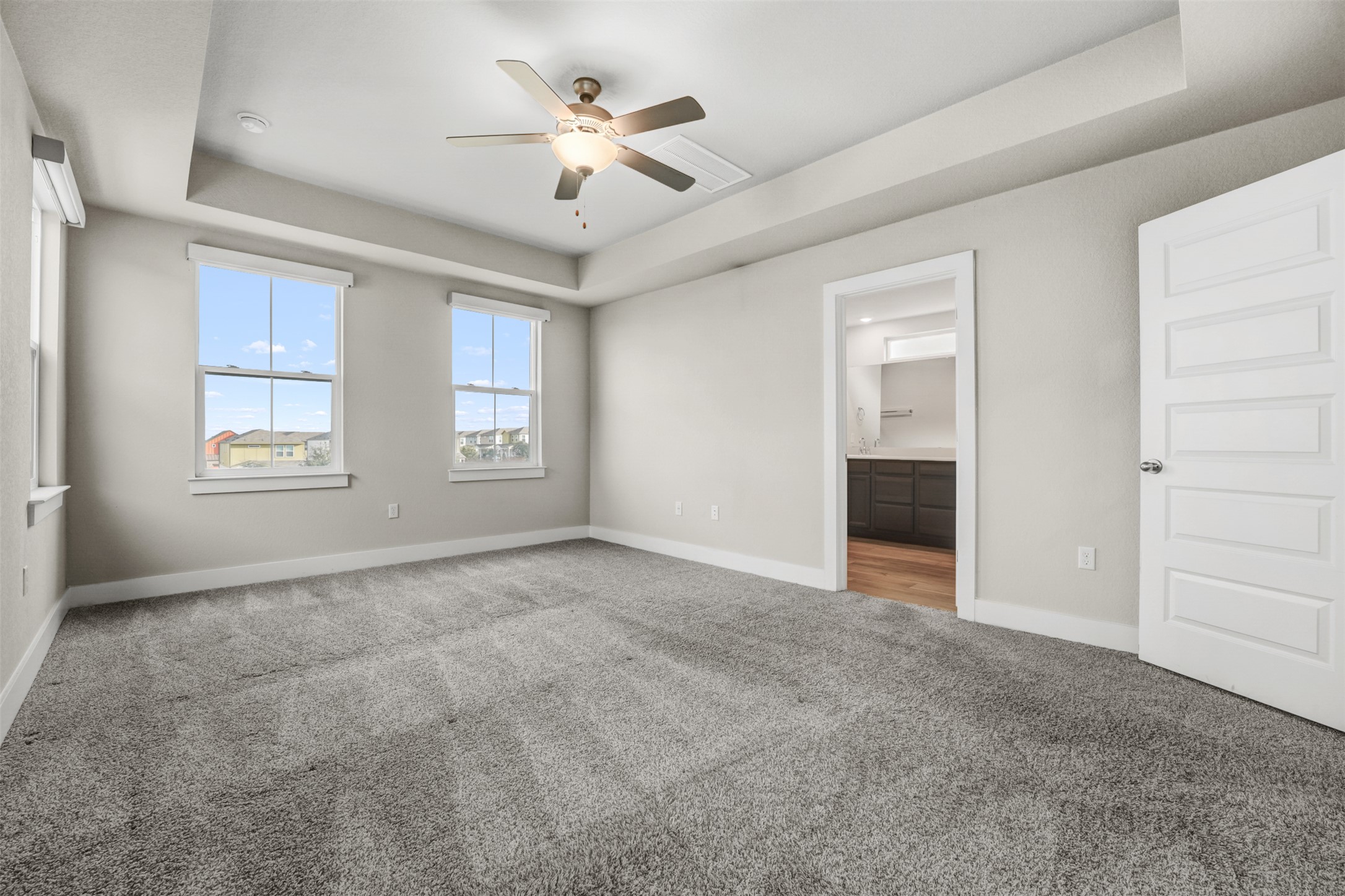 7509 Grand Linden Way, Unit 87 Austin, TX 78744 - Photo 15 of 30 an empty room with windows and ceiling fan