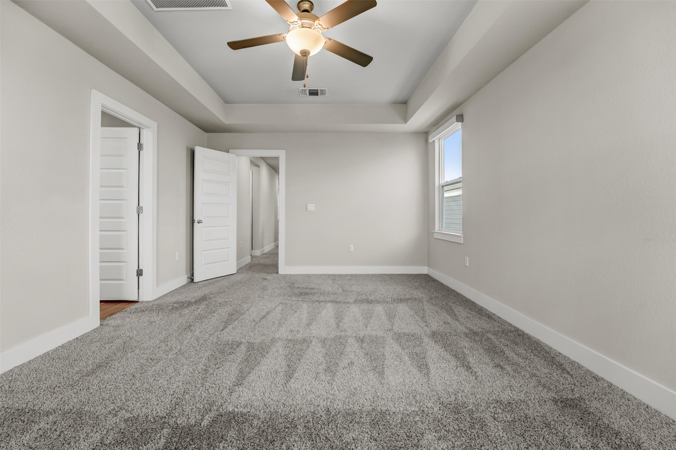 7509 Grand Linden Way, Unit 87 Austin, TX 78744 - Photo 16 of 30 an empty room with chandelier fan and windows