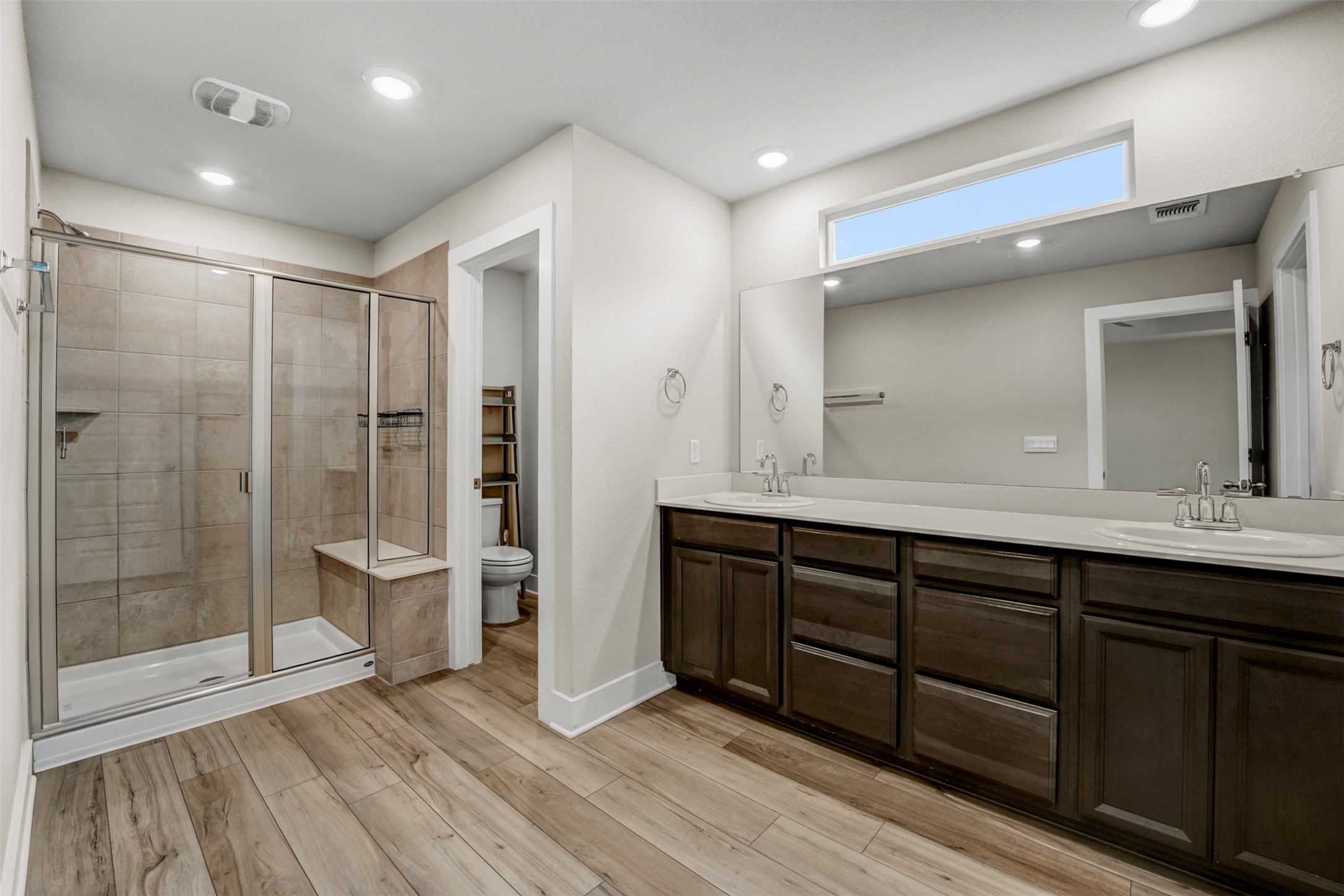 7509 Grand Linden Way, Unit 87 Austin, TX 78744 - Photo 17 of 30 a bathroom with a double vanity sink mirror and shower