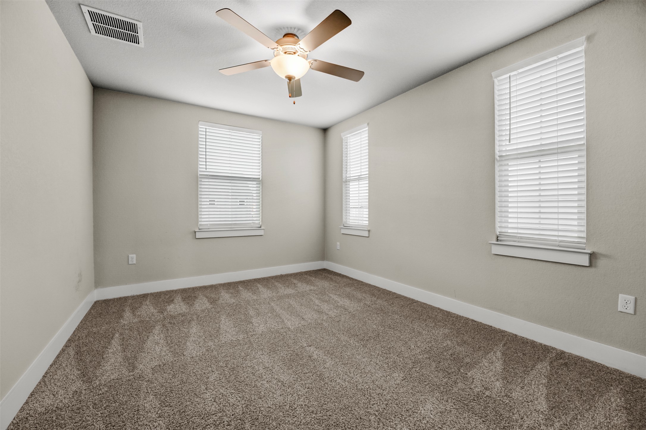 7509 Grand Linden Way, Unit 87 Austin, TX 78744 - Photo 19 of 30 an empty room with windows and fan
