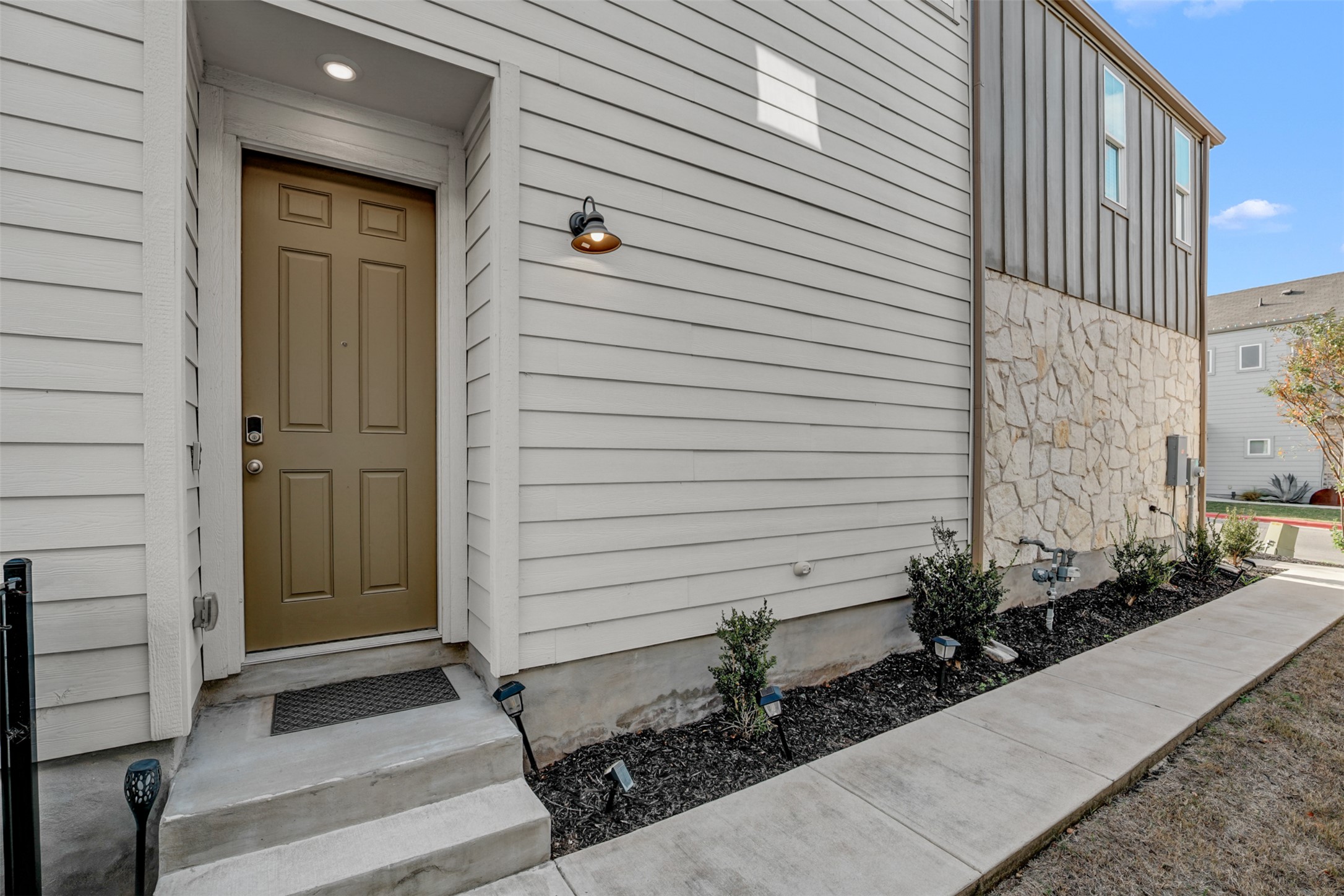7509 Grand Linden Way, Unit 87 Austin, TX 78744 - Photo 2 of 30 a view of house with wooden door