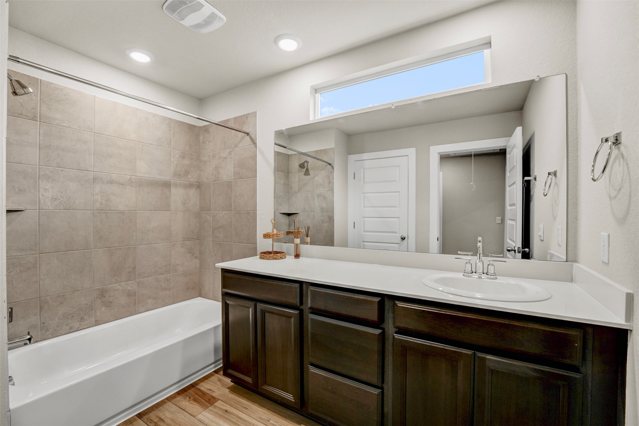 7509 Grand Linden Way, Unit 87 Austin, TX 78744 - Photo 23 of 30 a bathroom with a bathtub double vanity sink and mirror