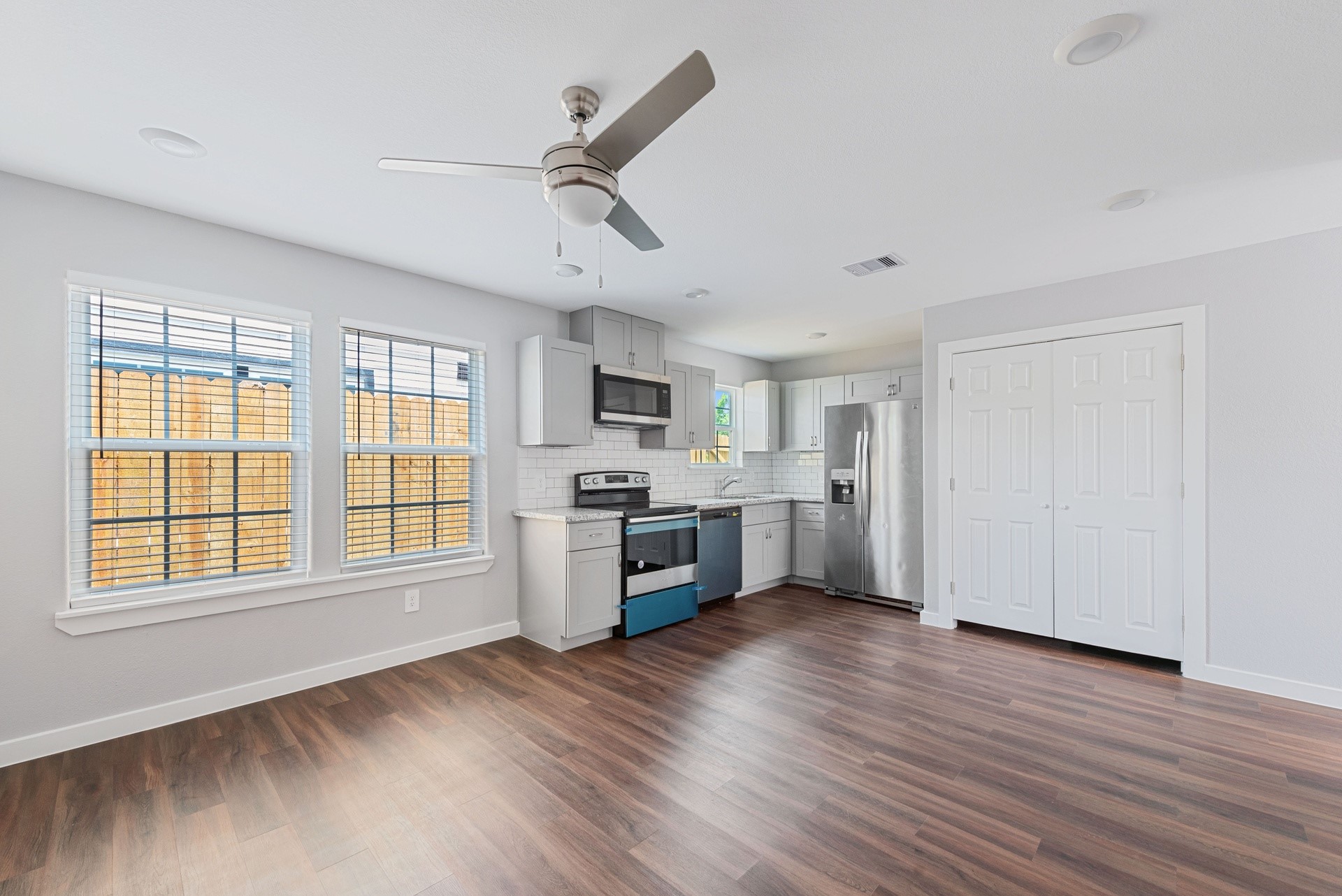 6809 Glass Street Houston, TX 77016 - Photo 16 of 29 a large kitchen with cabinets wooden floor and stainless steel appliances