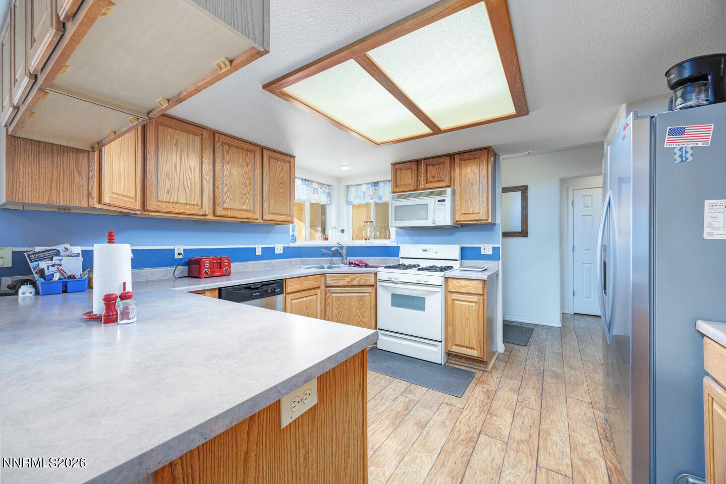2100 Birch Lane Fallon, NV 89406 - Photo 5 of 27 a kitchen with granite countertop a stove a sink dishwasher and a refrigerator with wooden cabinets