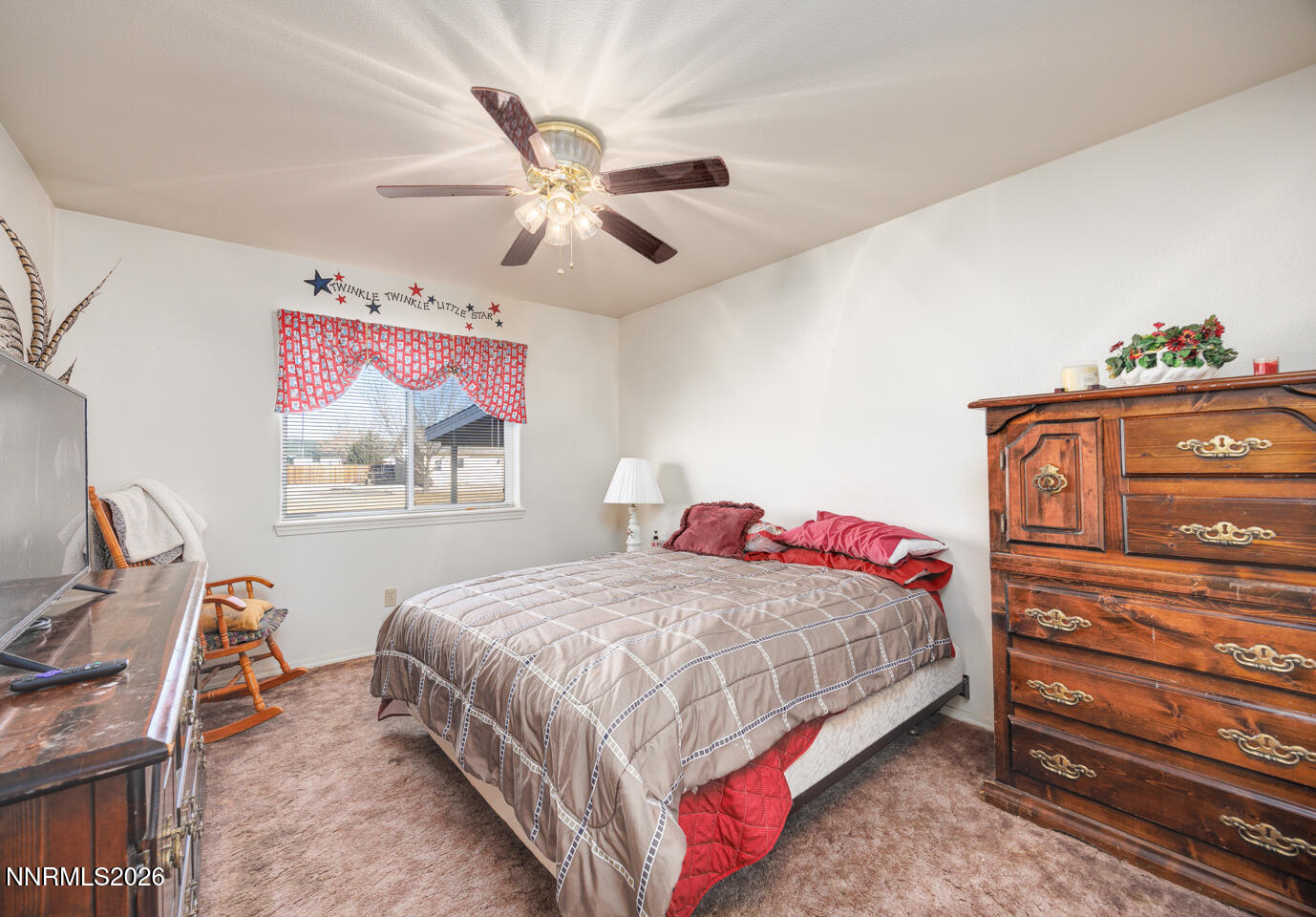 2100 Birch Lane Fallon, NV 89406 - Photo 8 of 27 a bedroom with a bed a dresser and chair