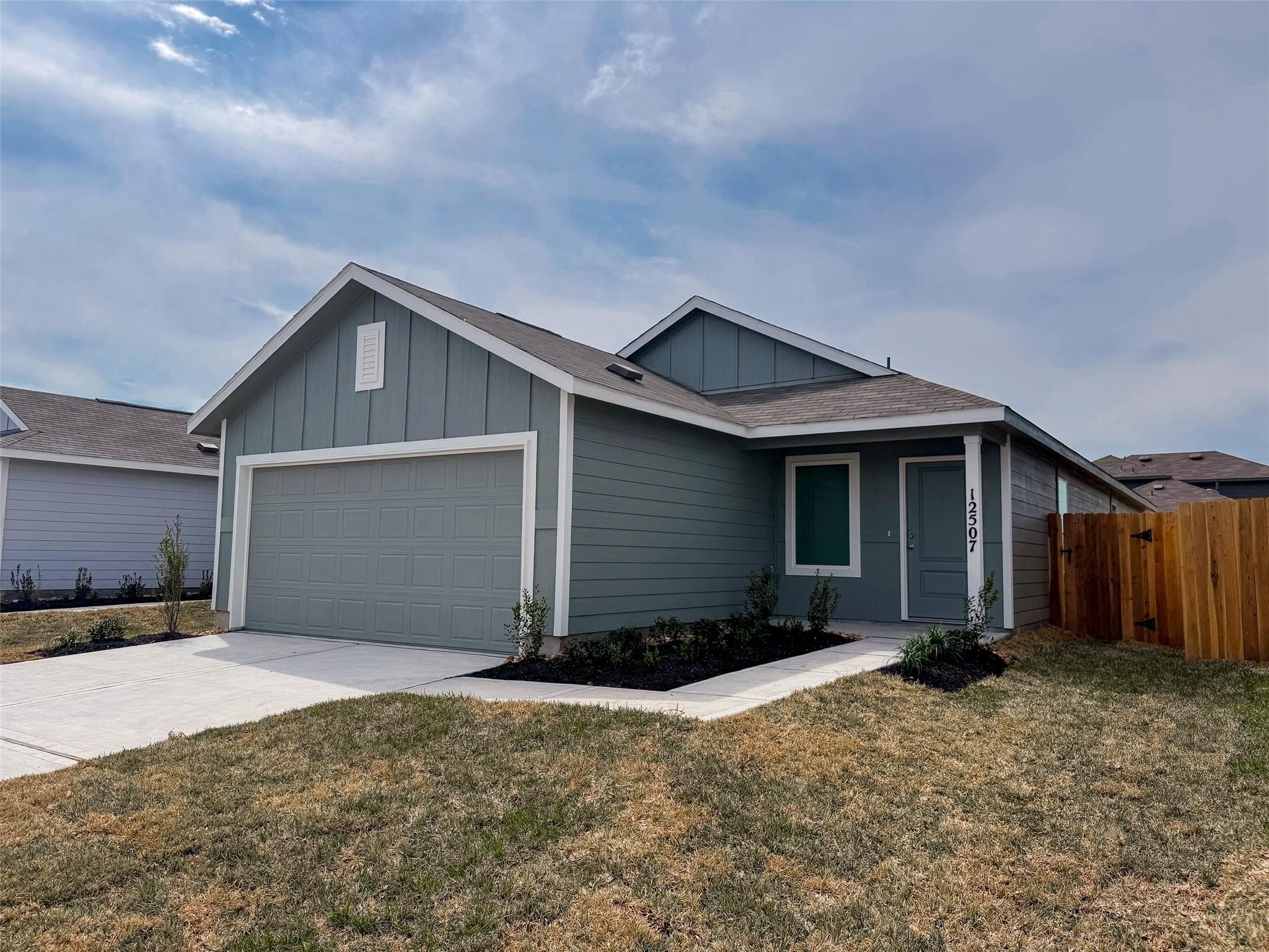 12431 Wild Strawberry Road Houston, TX 77038 - Photo 1 of 18 a view of a house with a yard and garage