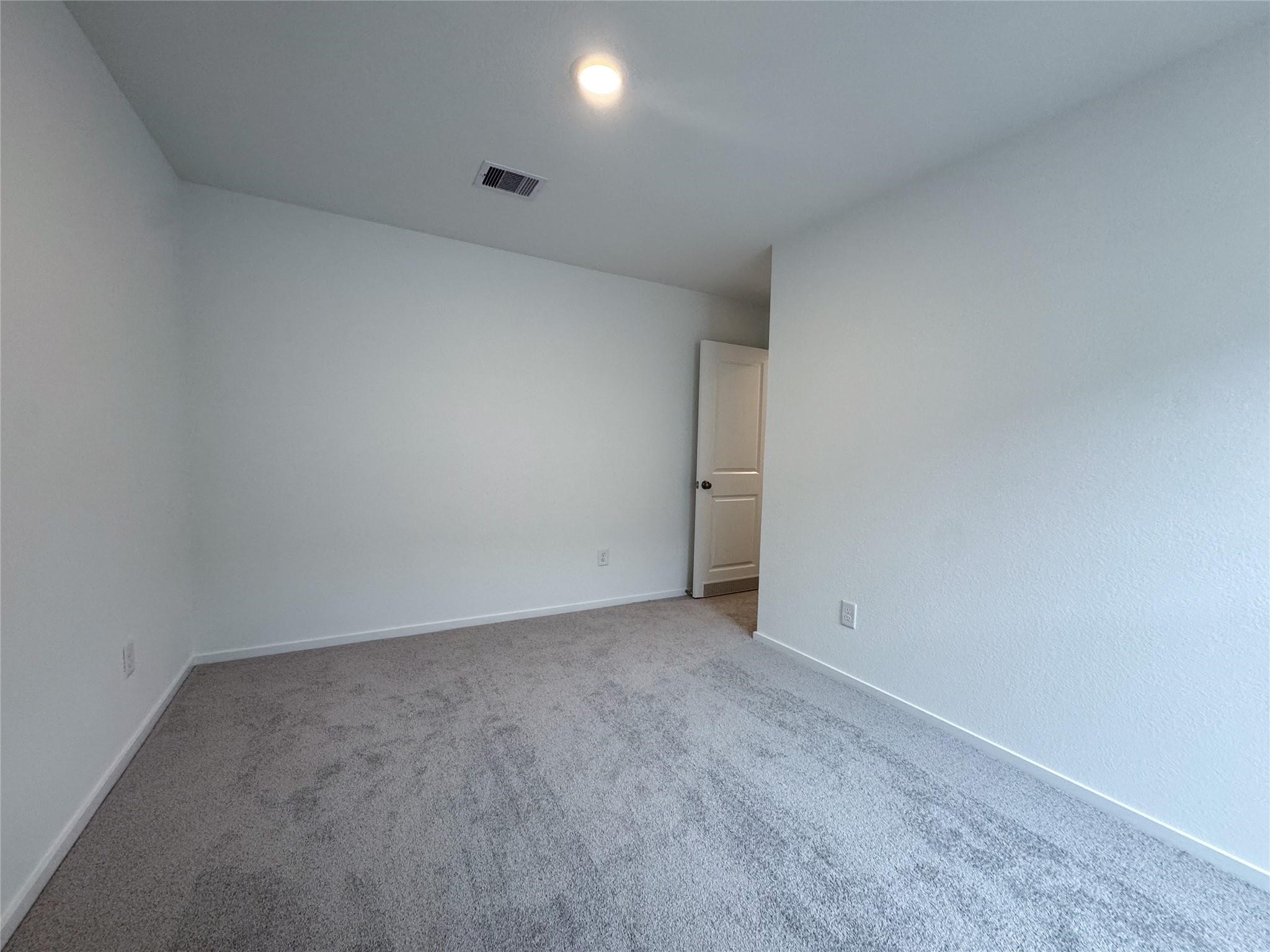 12431 Wild Strawberry Road Houston, TX 77038 - Photo 11 of 18 an empty room with an entryway