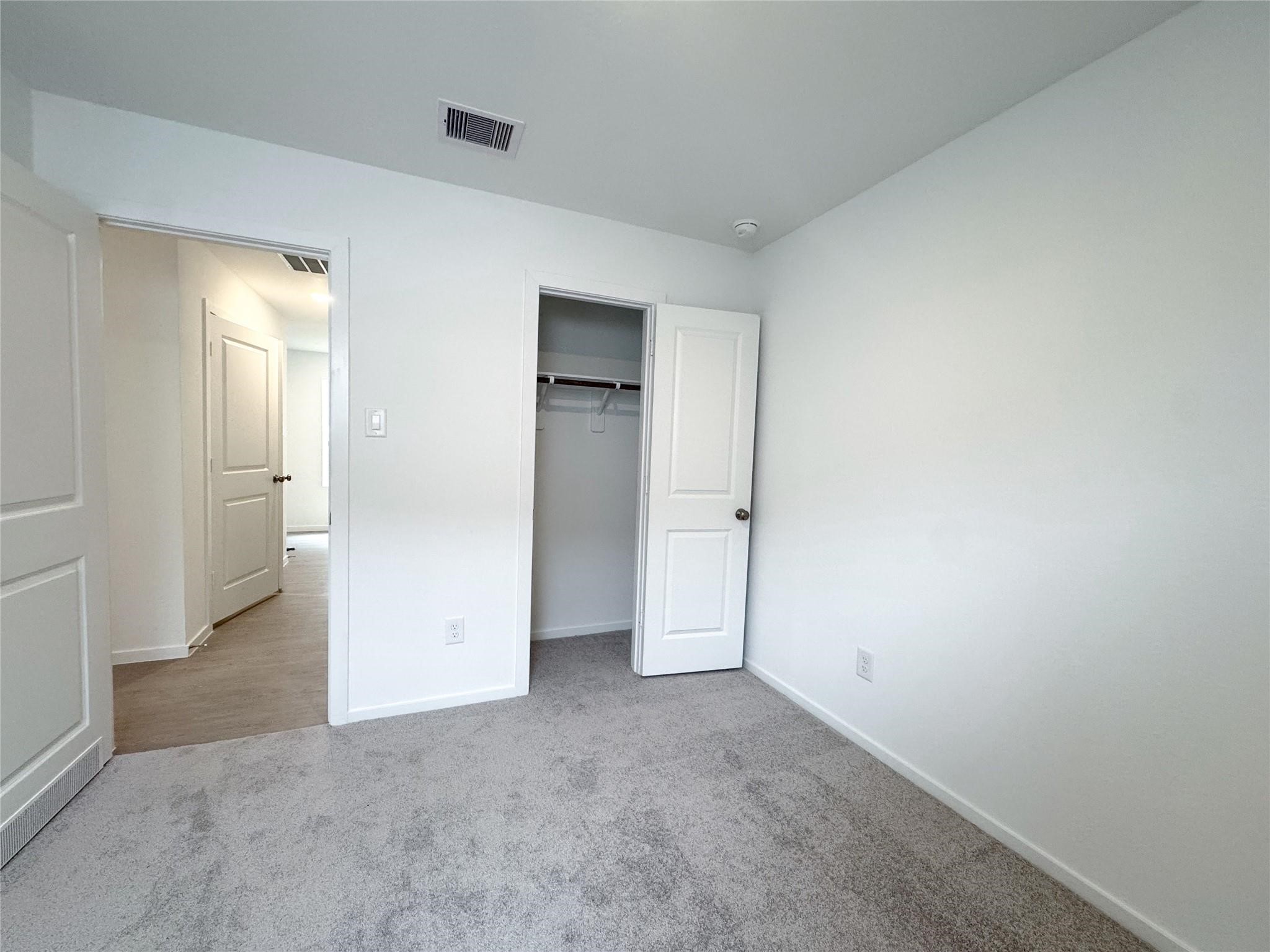 12431 Wild Strawberry Road Houston, TX 77038 - Photo 12 of 18 an empty room with an entryway