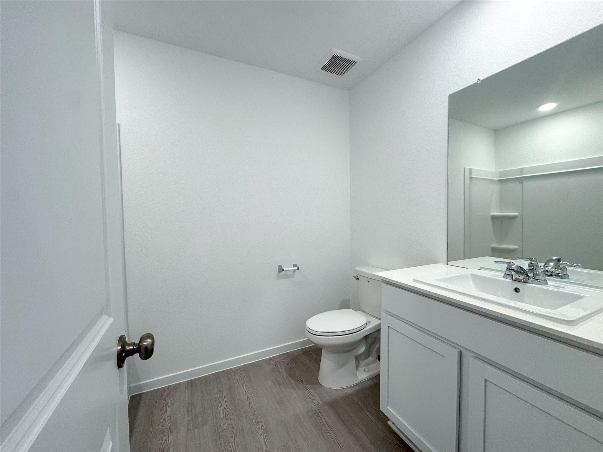 12431 Wild Strawberry Road Houston, TX 77038 - Photo 13 of 18 a bathroom with a sink and a mirror