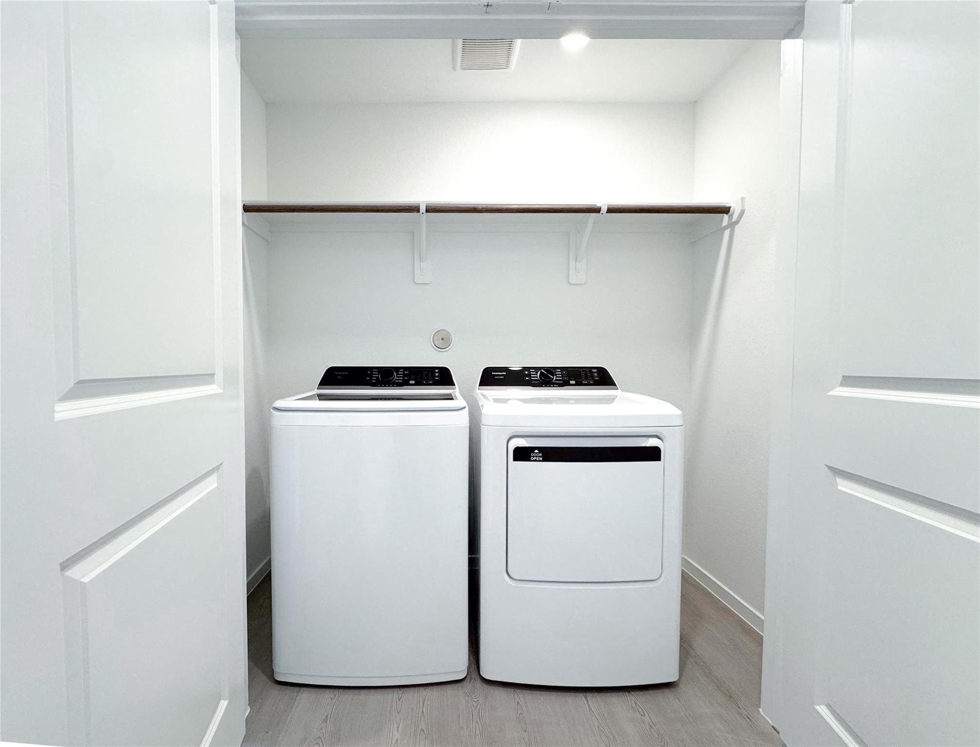 12431 Wild Strawberry Road Houston, TX 77038 - Photo 17 of 18 a utility room with dryer and washer