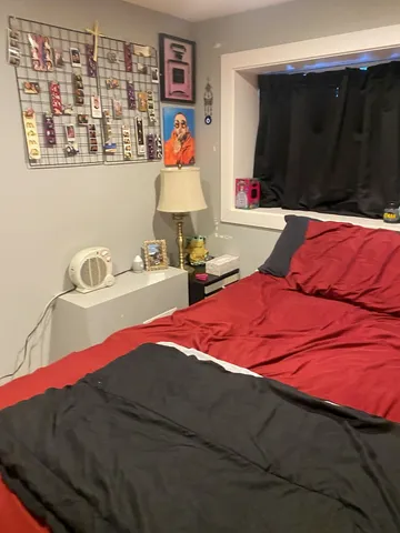 a bedroom with a bed and a cabinet