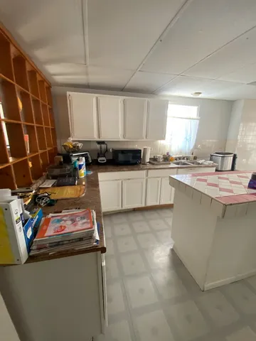 a kitchen with a sink appliances and cabinets