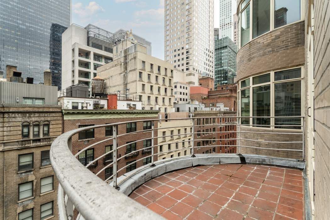 24 West 55th Street, Unit 10E Manhattan, NY 10019 - Photo 10 of 12 a front view of a building with a street