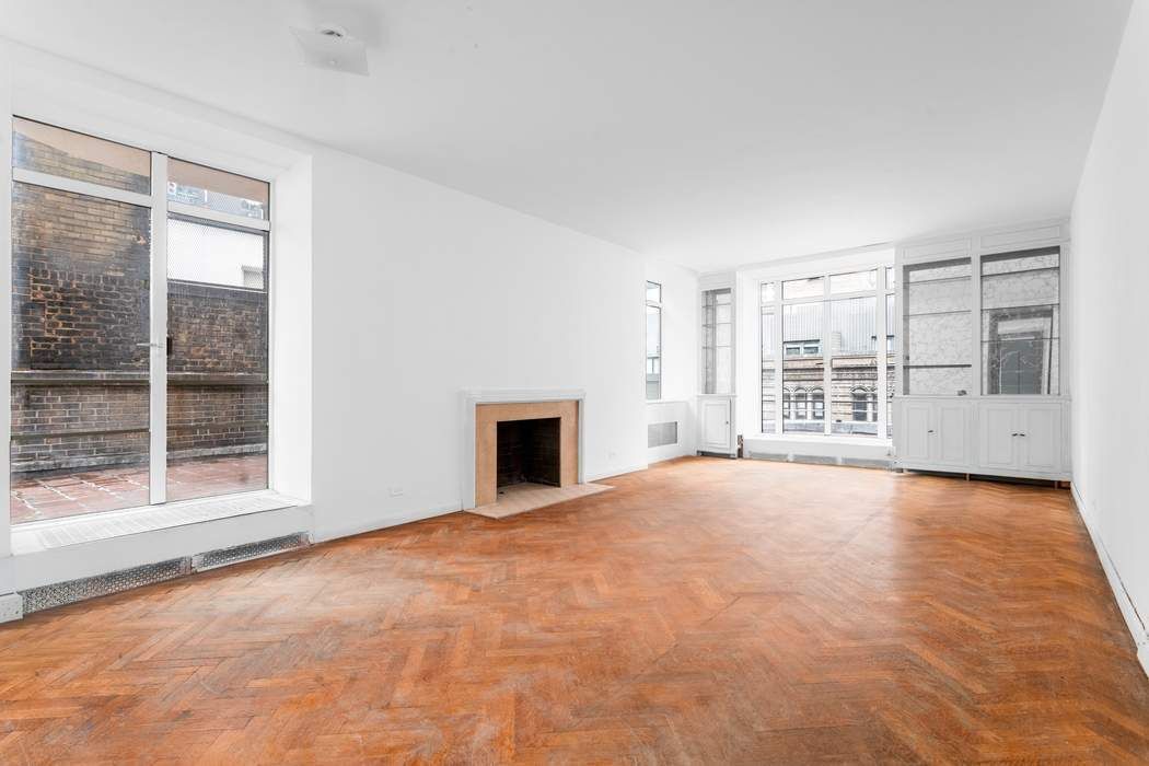 24 West 55th Street, Unit 10E Manhattan, NY 10019 - Photo 2 of 12 a view of an empty room with a fireplace and a window