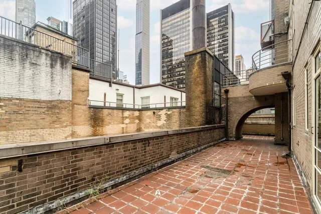 a view of balcony with couches table and chairs