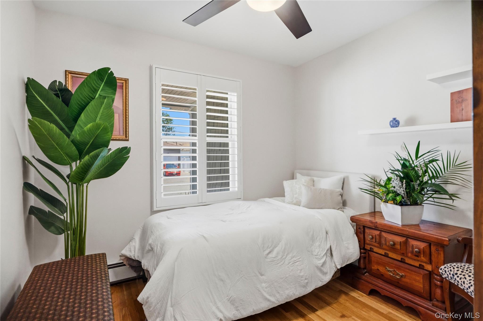 190 Sexton Road West Babylon, NY 11704 - Photo 20 of 28 a bedroom with a bed a potted plant and a window