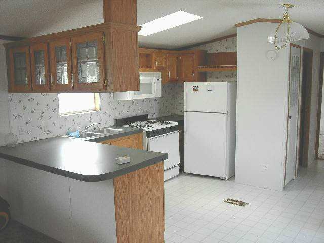 3998 South Baileyville Road Freeport, IL 61032 - Photo 4 of 5 a kitchen with stainless steel appliances granite countertop a sink stove and refrigerator