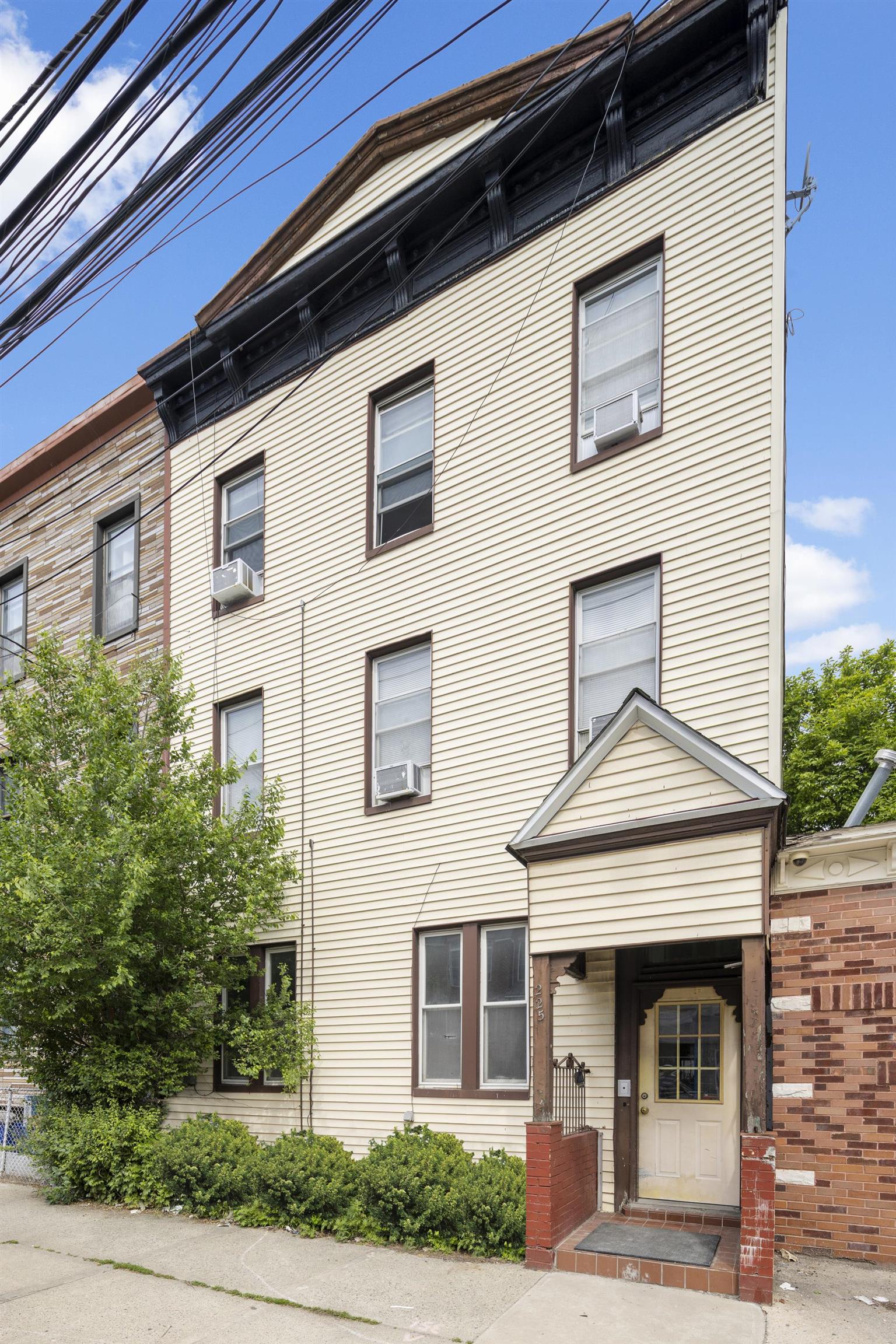 225 Pine Street, Unit 1 Jersey City, NJ 07304 - Photo 11 of 11 a front view of a house with garden
