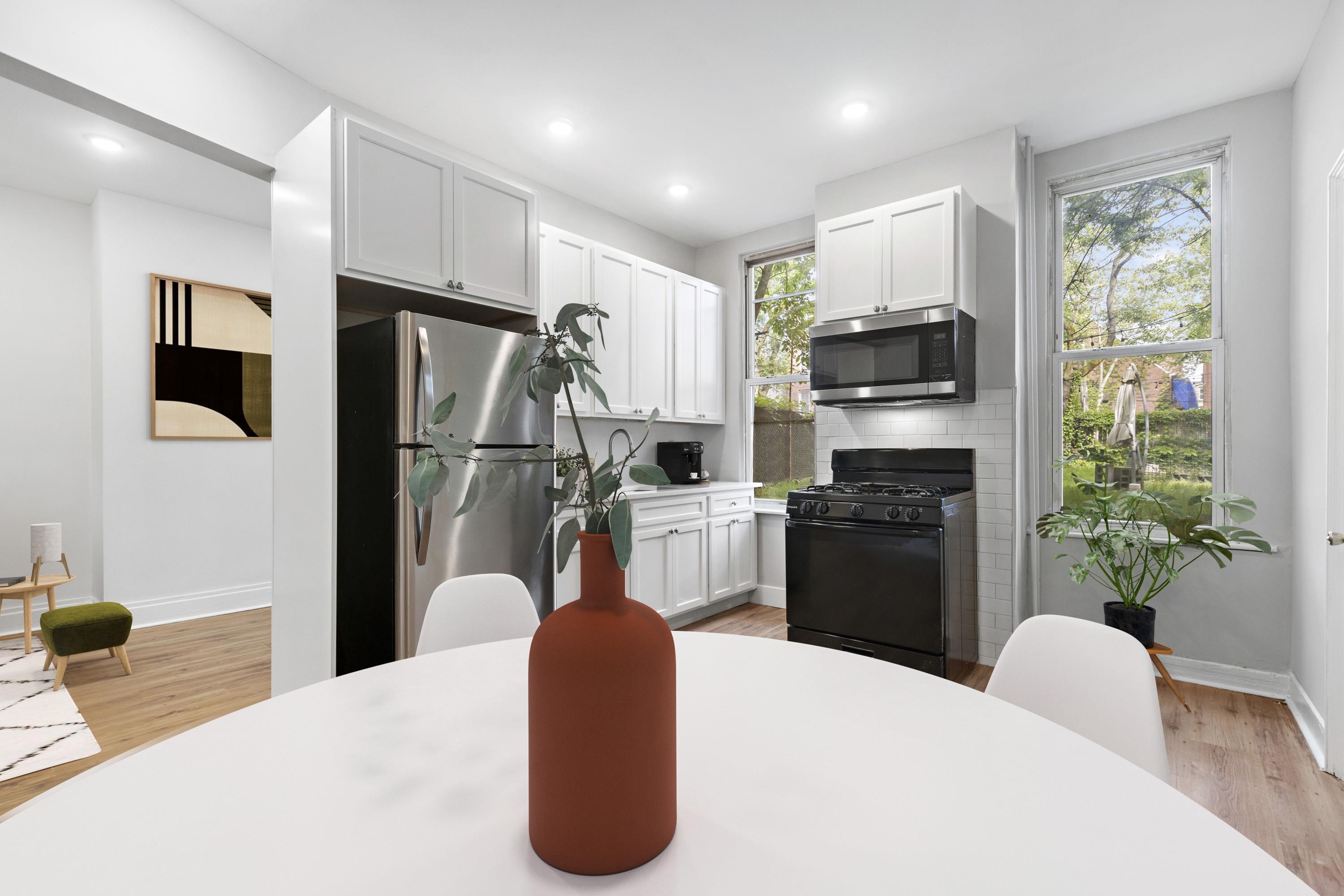 225 Pine Street, Unit 1 Jersey City, NJ 07304 - Photo 2 of 11 a kitchen with stainless steel appliances a refrigerator sink and stove
