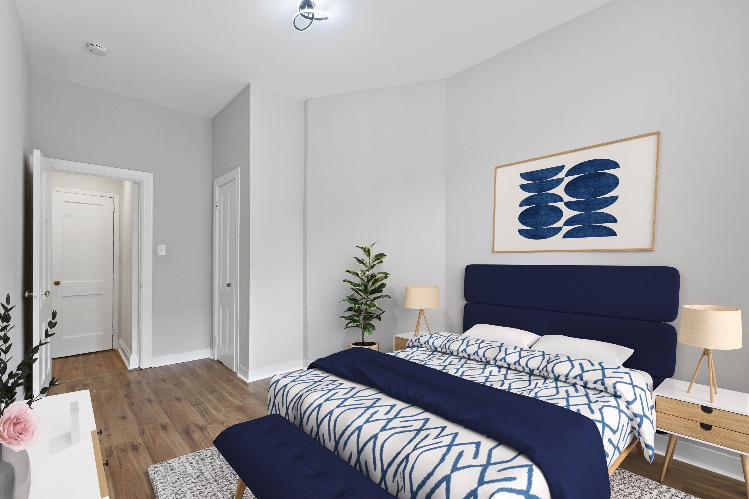 225 Pine Street, Unit 1 Jersey City, NJ 07304 - Photo 7 of 11 a bedroom with a bed and a lamp