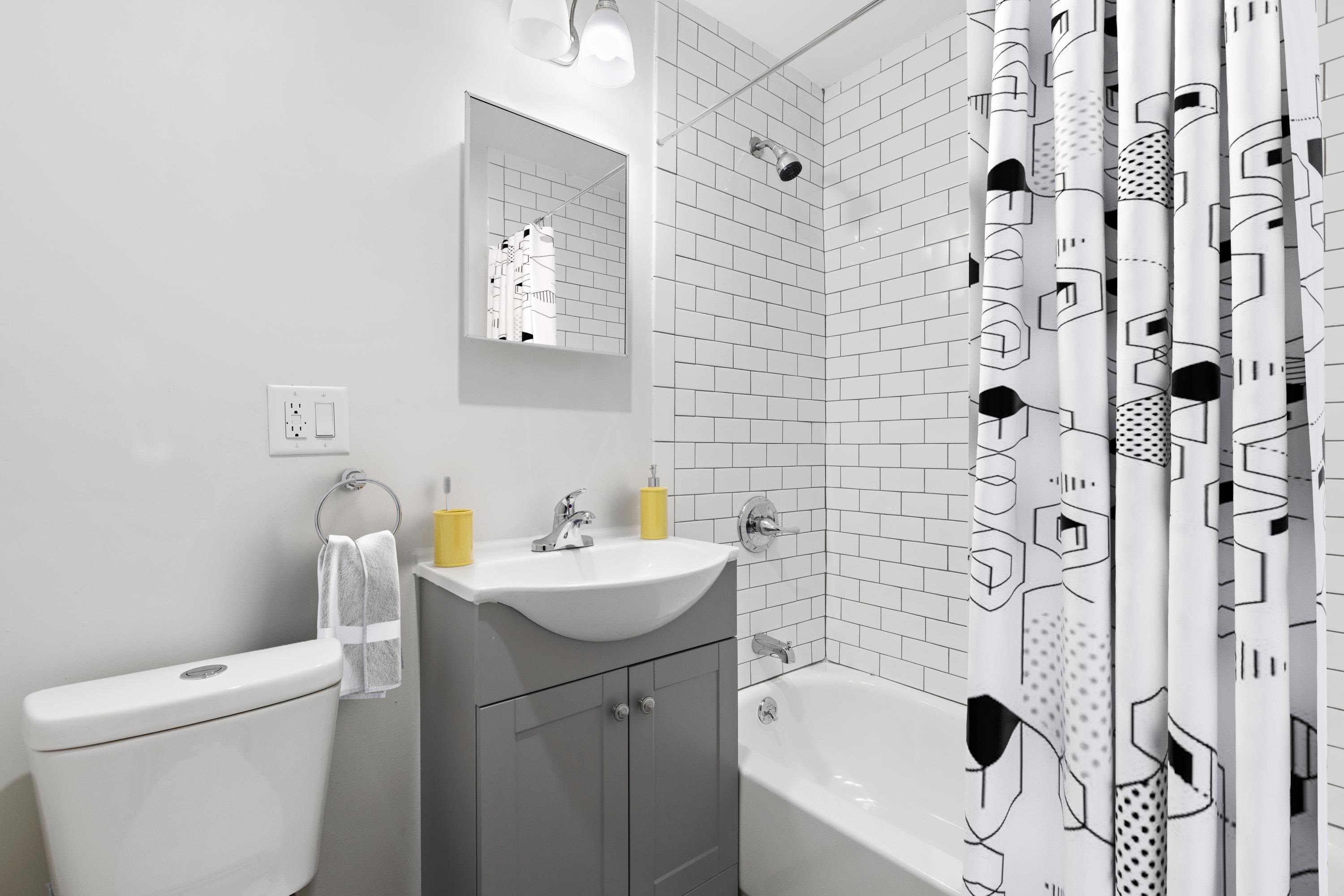 225 Pine Street, Unit 1 Jersey City, NJ 07304 - Photo 8 of 11 a bathroom with a sink toilet and shower