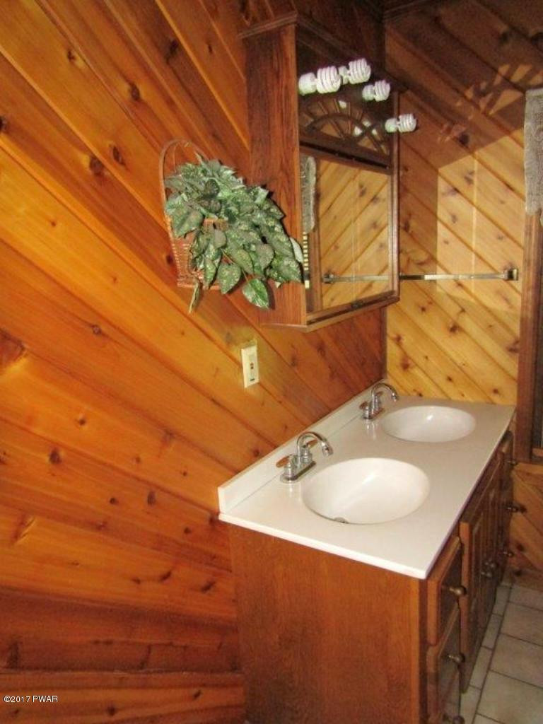 227 Hemlock Grove Road Newfoundland, PA 18445 - Photo 33 of 49 a bathroom with a sink and a mirror