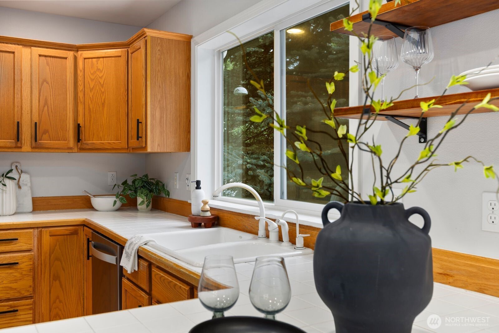 4405 South 261st Street Kent, WA 98032 - Photo 11 of 31 a view of a kitchen with furniture and a potted plant
