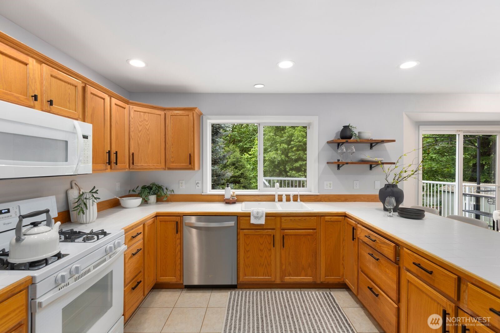 4405 South 261st Street Kent, WA 98032 - Photo 10 of 31 a kitchen with a sink stove and cabinets