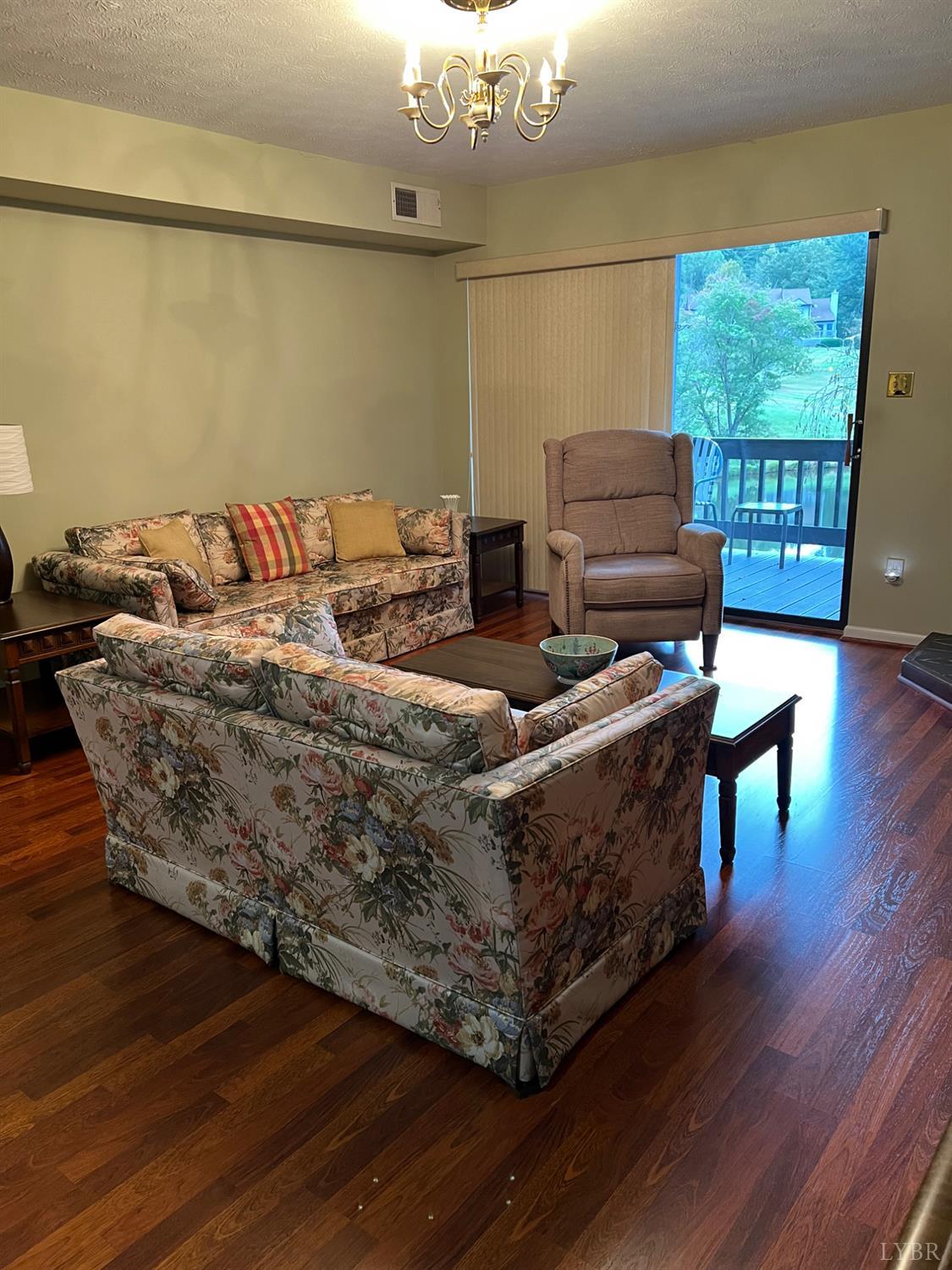 2212 Deer Run Forest, VA 24551 - Photo 27 of 38 a living room with furniture and a chandelier