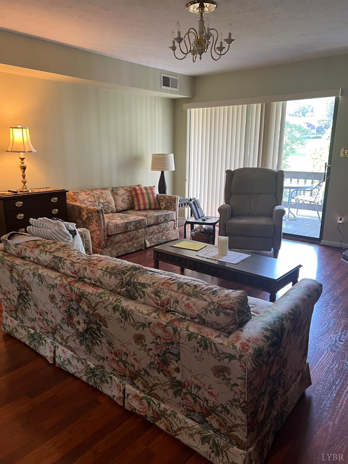 2212 Deer Run Forest, VA 24551 - Photo 6 of 38 a living room with furniture a chandelier and a window