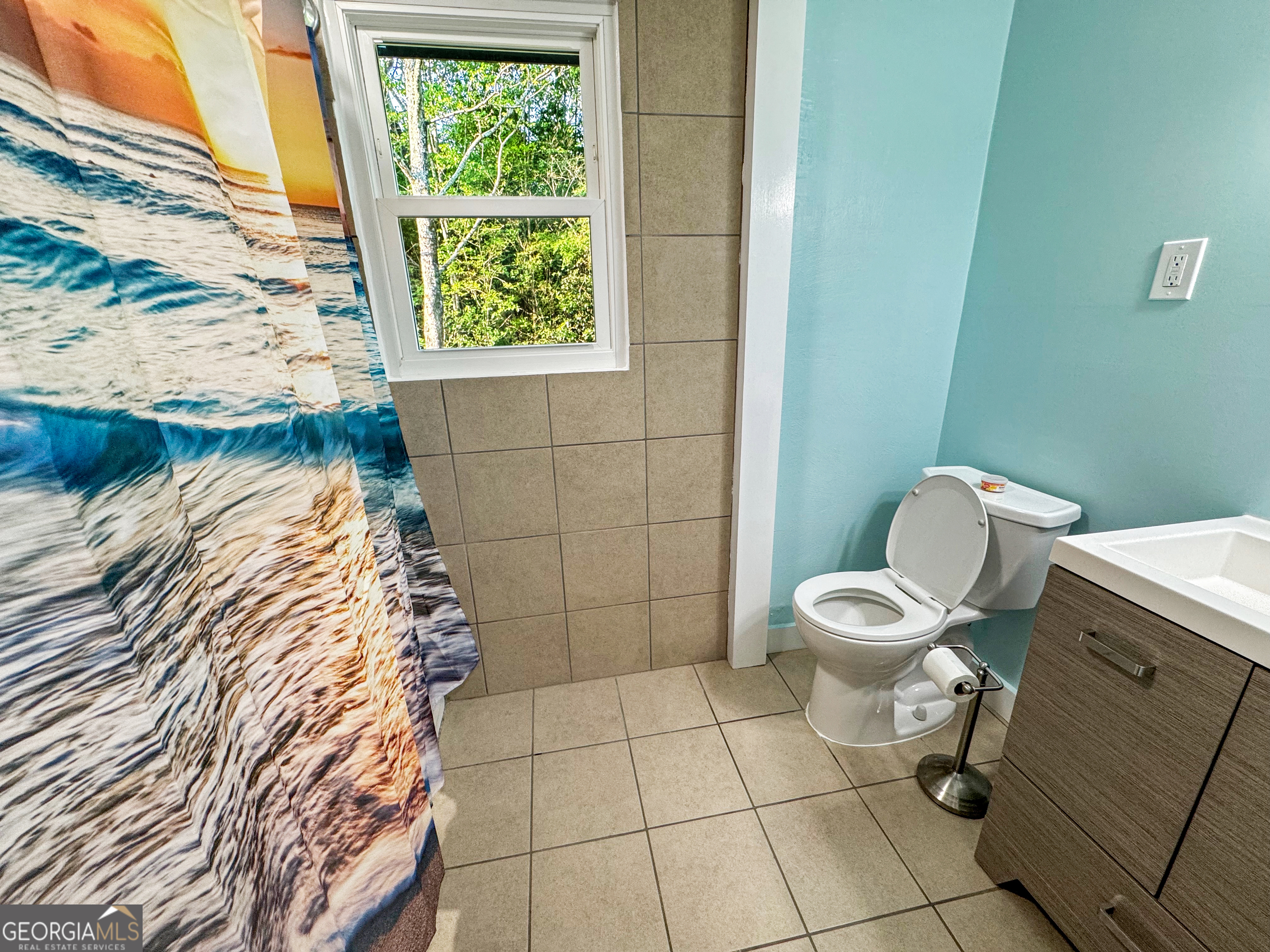 514 Highway 18 Barnesville, GA 30204 - Photo 11 of 15 a bathroom with a toilet and a shower curtain