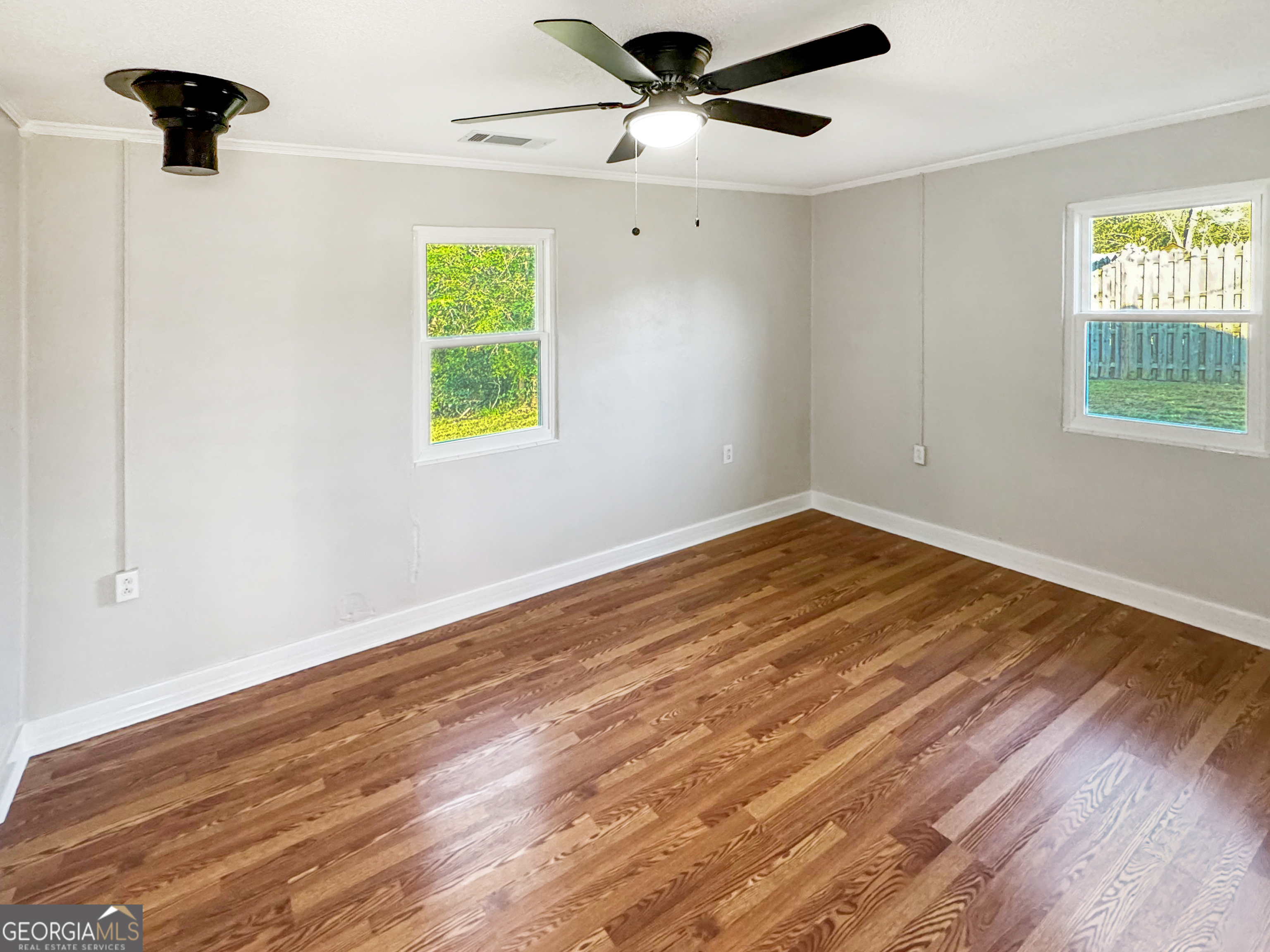 514 Highway 18 Barnesville, GA 30204 - Photo 13 of 15 a view of empty room with wooden floor and fan