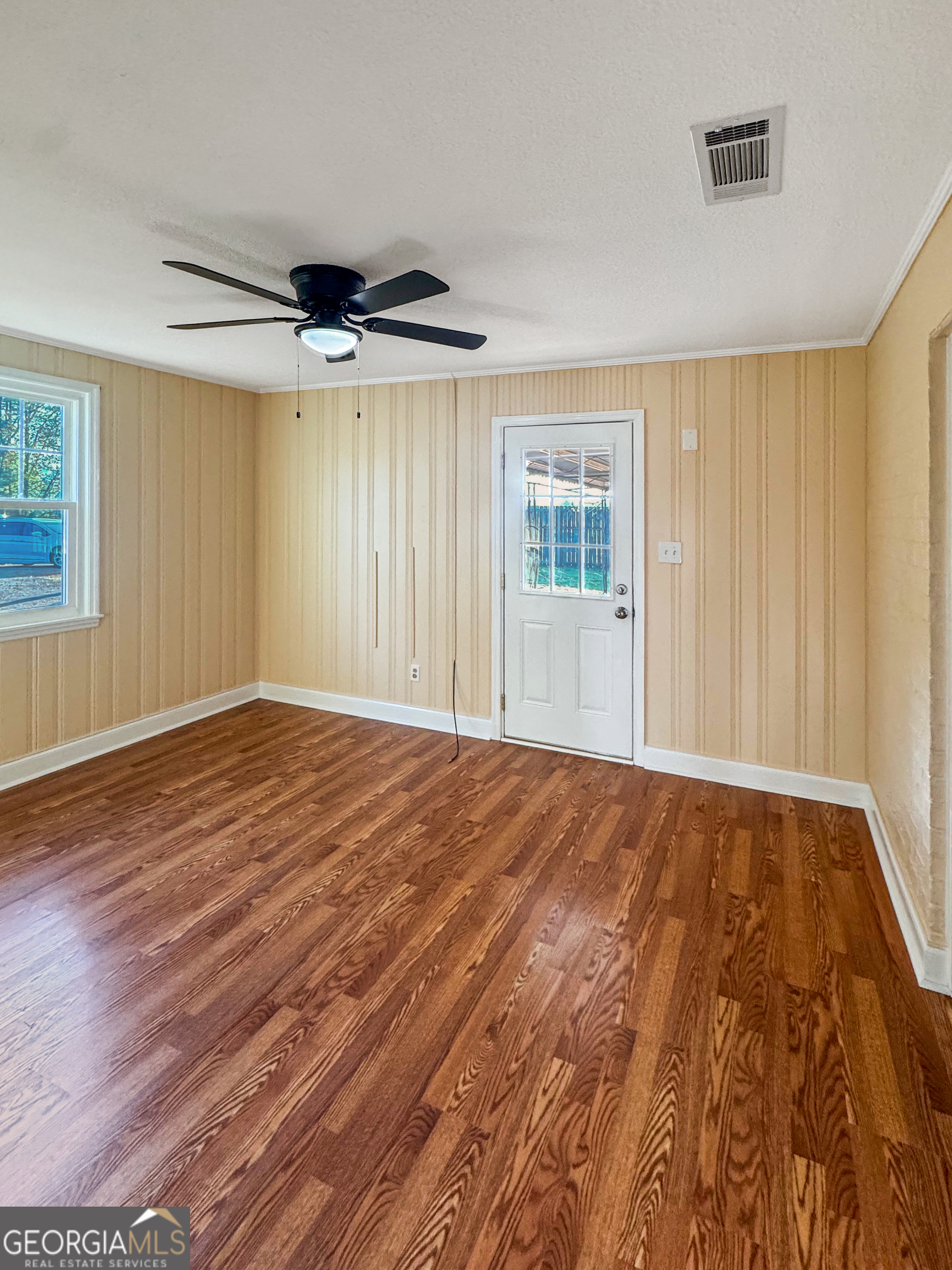 514 Highway 18 Barnesville, GA 30204 - Photo 3 of 15 a view of an empty room with a window and wooden floor