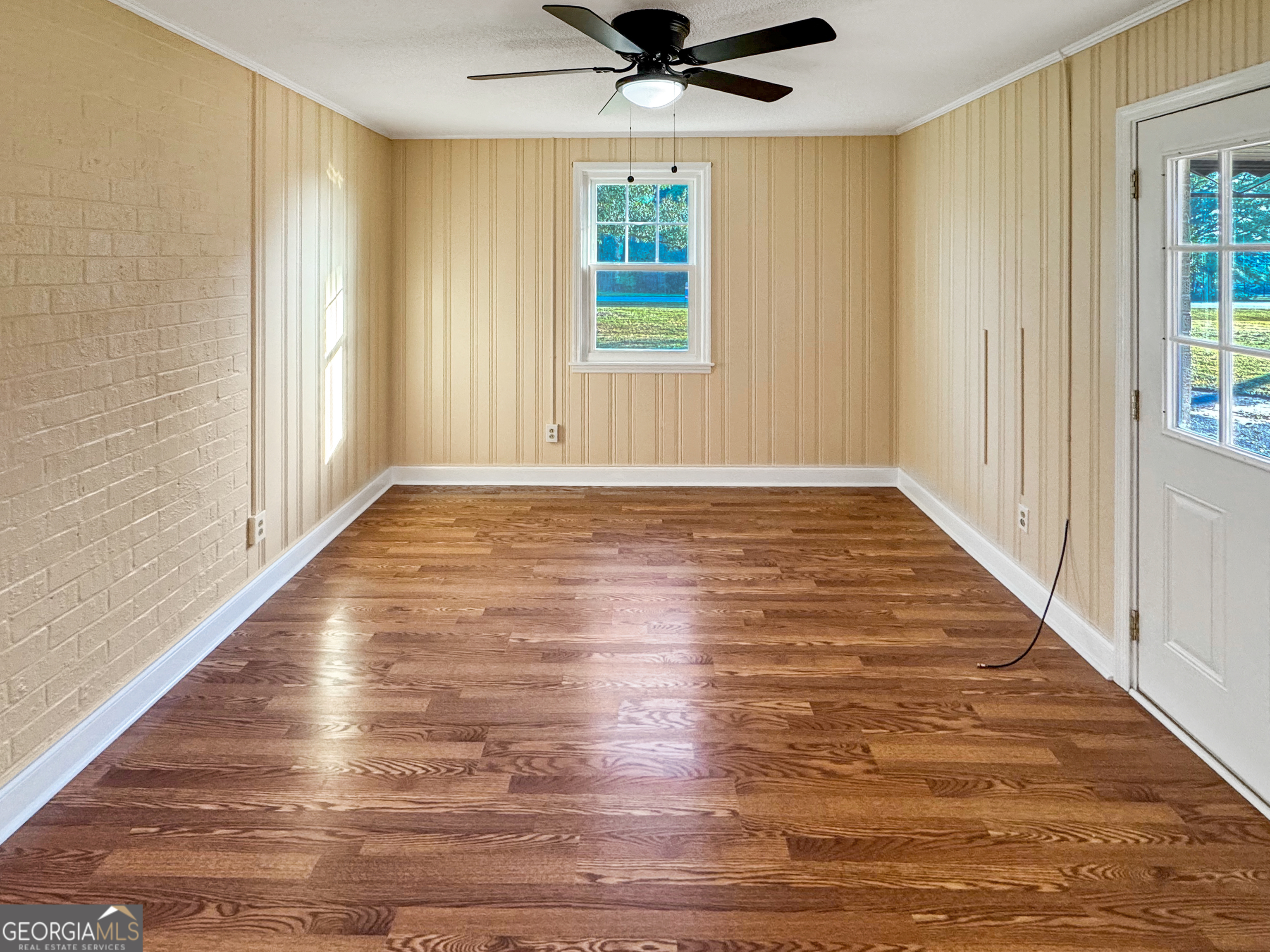 514 Highway 18 Barnesville, GA 30204 - Photo 4 of 15 a view of a livingroom with wooden floor and a window