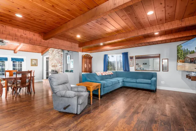 a living room with furniture and wooden floors