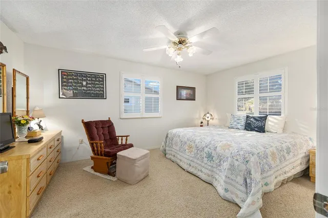 a front view of house with yard and trees in the background