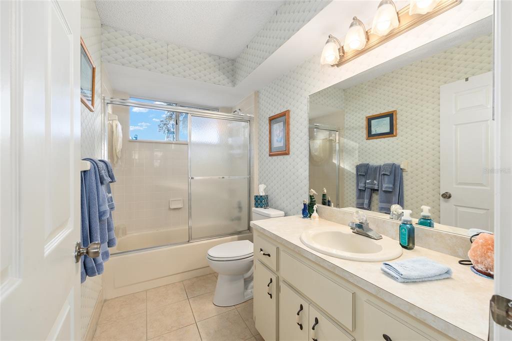 10913 Southwest 83rd Avenue Ocala, FL 34481 - Photo 20 of 48 a bathroom with a granite countertop sink mirror vanity and toilet