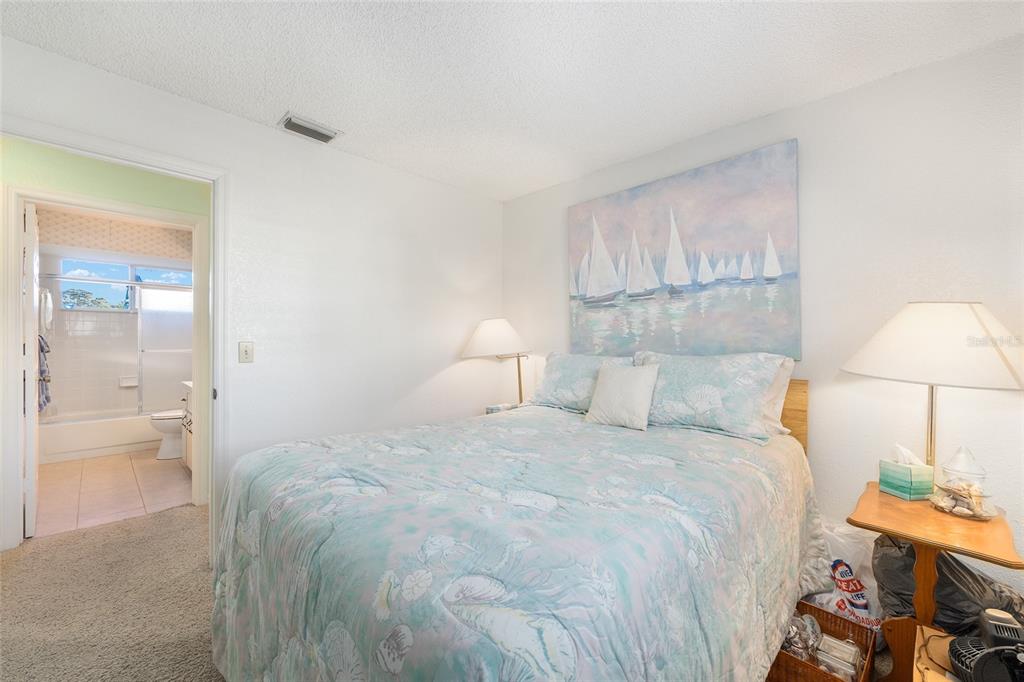 10913 Southwest 83rd Avenue Ocala, FL 34481 - Photo 21 of 48 a bedroom with a bed and a lamp