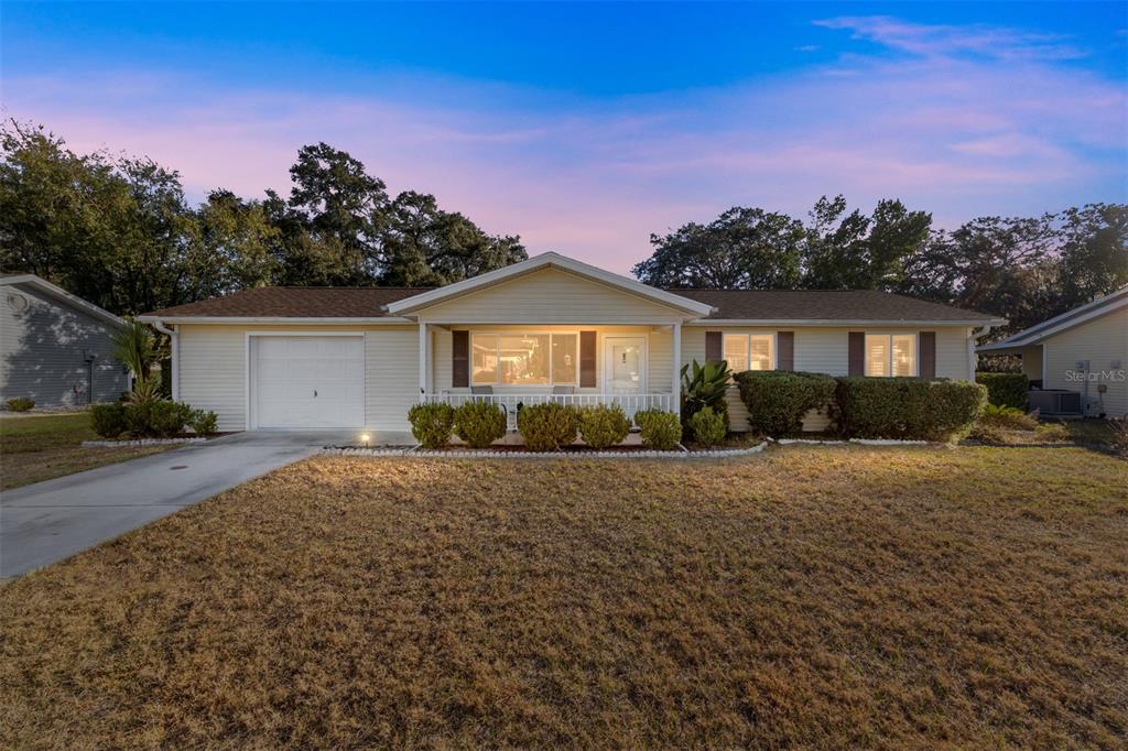 10913 Southwest 83rd Avenue Ocala, FL 34481 - Photo 28 of 48 a front view of house with yard and trees in the background