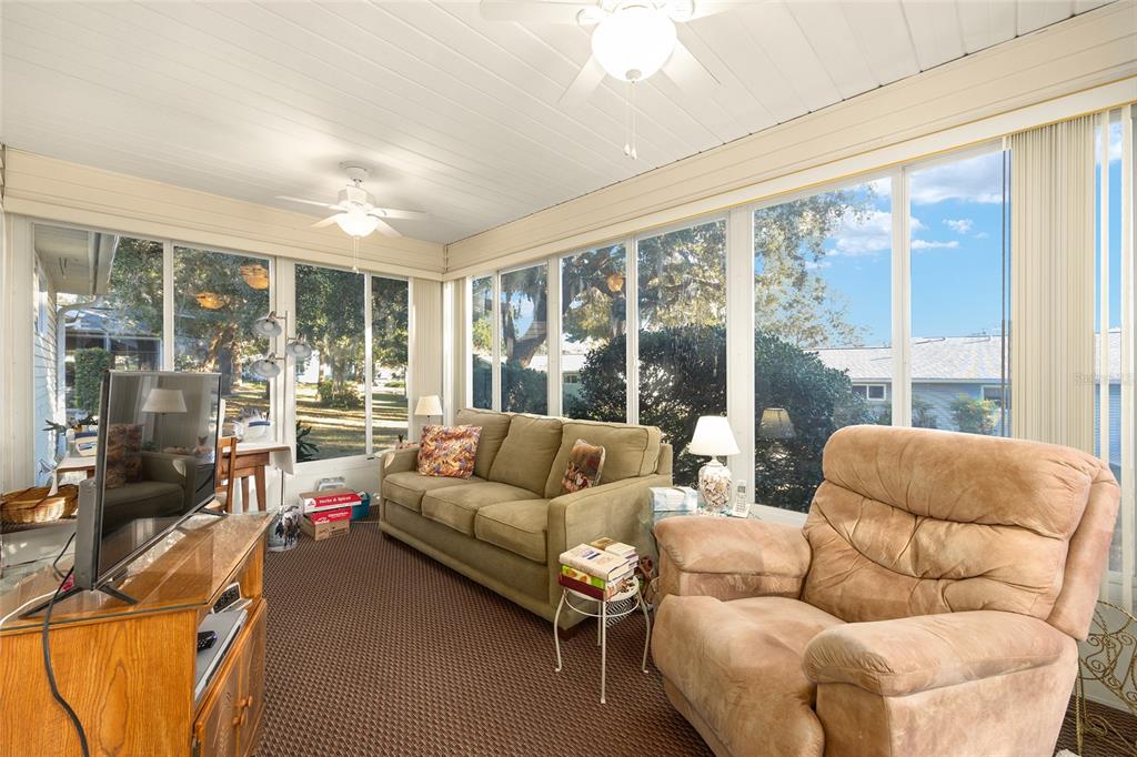 10913 Southwest 83rd Avenue Ocala, FL 34481 - Photo 37 of 48 a living room with furniture and a large window