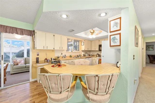 a view of a kitchen with a dining table and chairs