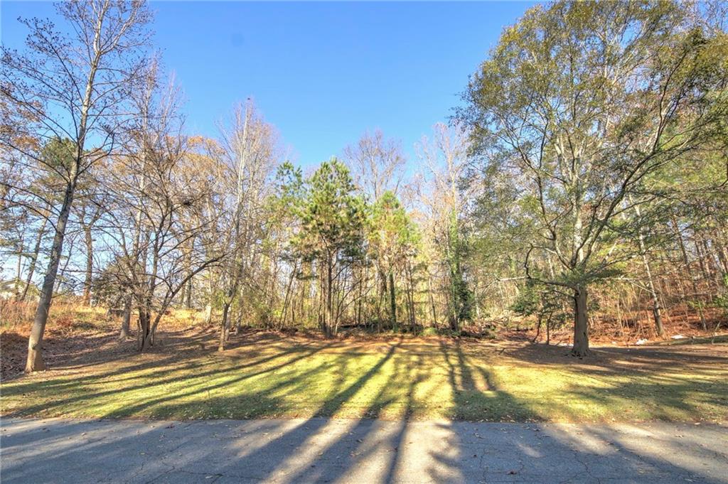 1145 Gun Club Road Northwest Atlanta, GA 30318 - Photo 1 of 10 a view of a yard with swimming pool and trees