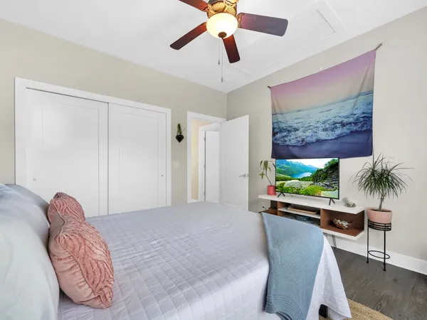 a bedroom with furniture and a large window