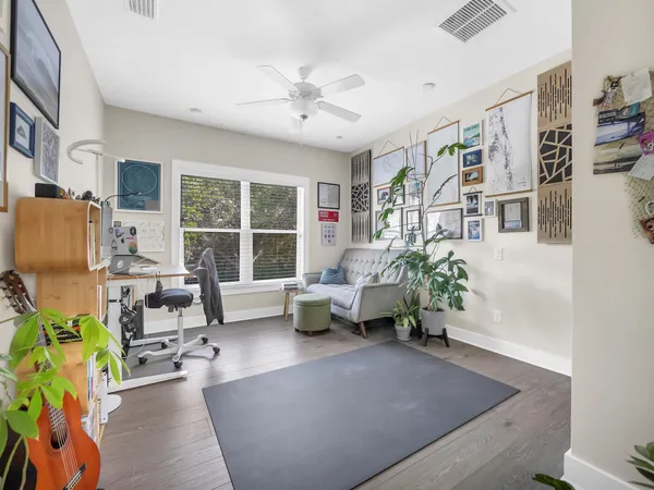 a living room with furniture and a potted plant