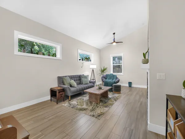 a living room with furniture and wooden floor