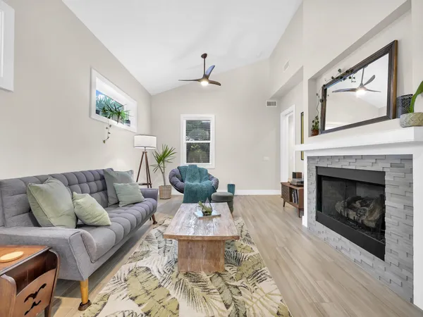 a living room with furniture and a fireplace