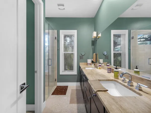 a large bathroom with a granite countertop sink a mirror and a shower