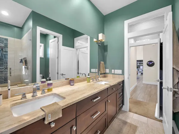 a bathroom with double vanity sinks and a mirror