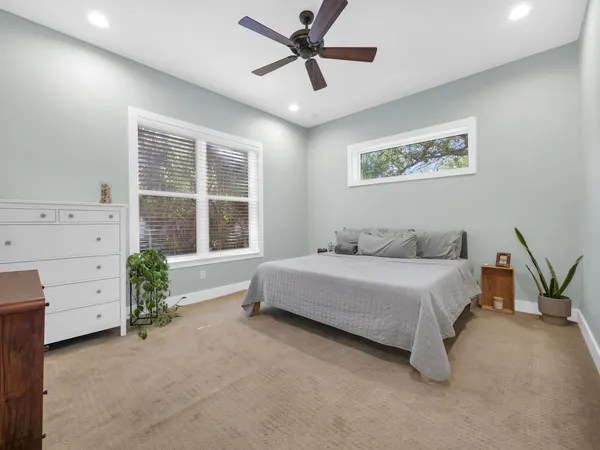 a spacious bedroom with a bed and a window
