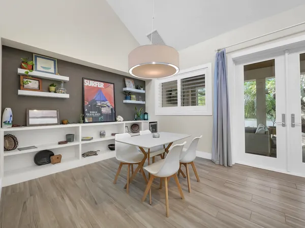 a view of a dining room with furniture and wooden floor